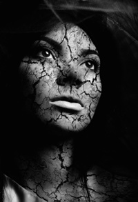 Close-up portrait of beautiful young woman with cracked skin